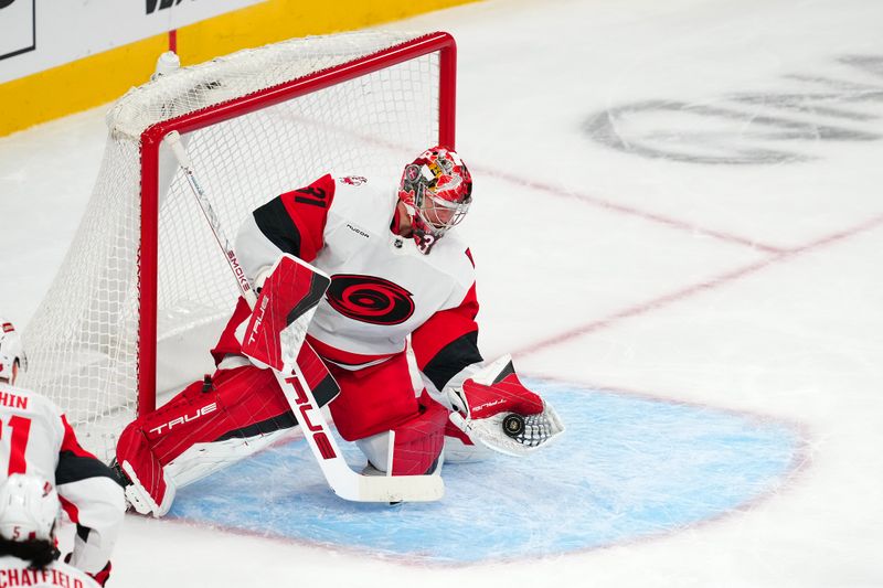 Oct 20, 2025; Las Vegas, Nevada, USA; Carolina Hurricanes goaltender Frederik Anderson (31) makes a glove save against the Vegas Golden Knights during the second period at T-Mobile Arena. Mandatory Credit: Stephen R. Sylvanie-Imagn Images