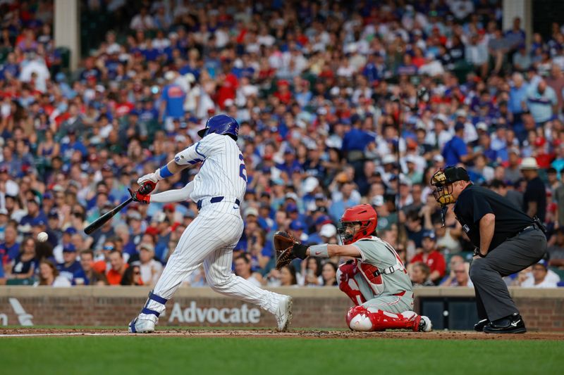 Jul 2, 2024; Chicago, Illinois, USA; Chicago Cubs outfielder Seiya Suzuki (27) hits a single against the Philadelphia Phillies during the first inning at Wrigley Field. Mandatory Credit: Kamil Krzaczynski-USA TODAY Sports