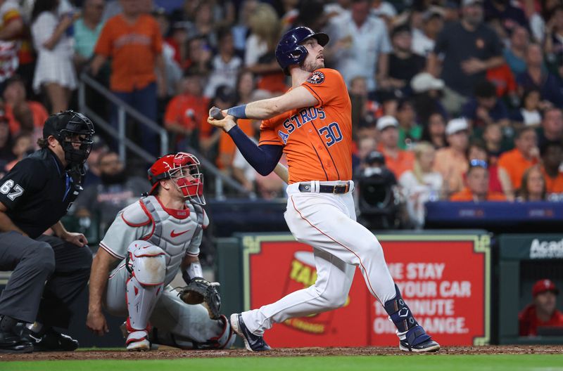 Apr 30, 2023; Houston, Texas, USA; Houston Astros right fielder Kyle Tucker (30) drives in a run with a single during the fifth inning against the Philadelphia Phillies at Minute Maid Park. Mandatory Credit: Troy Taormina-USA TODAY Sports