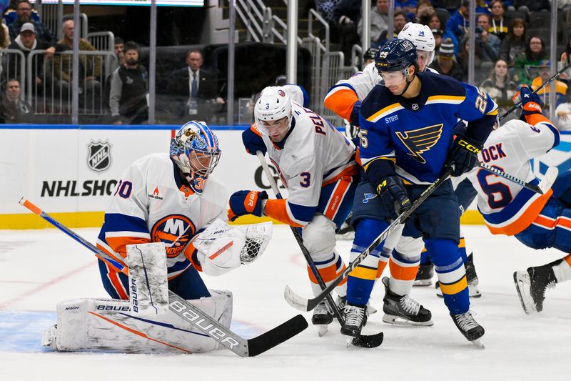 Oct 17, 2024; St. Louis, Missouri, USA;  New York Islanders goaltender Ilya Sorokin (30) makes a glove save as defenseman Adam Pelech (3) defends against St. Louis Blues center Jordan Kyrou (25) during the second period at Enterprise Center. Mandatory Credit: Jeff Curry-Imagn Images