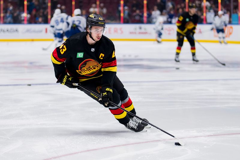 Dec 12, 2023; Vancouver, British Columbia, CAN; Vancouver Canucks defenseman Quinn Hughes (43) handles the puck during warm up prior to a game against the Tampa Bay Lightning at Rogers Arena. Mandatory Credit: Bob Frid-USA TODAY Sports