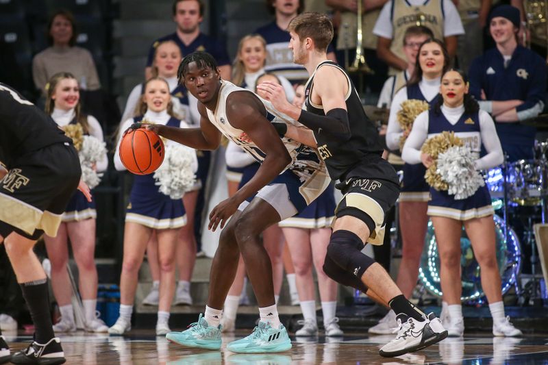 Feb 6, 2024; Atlanta, Georgia, USA; Georgia Tech Yellow Jackets forward Baye Ndongo (11) is defended by Wake Forest Demon Deacons forward Andrew Carr (11) in the first half at McCamish Pavilion. Mandatory Credit: Brett Davis-USA TODAY Sports
