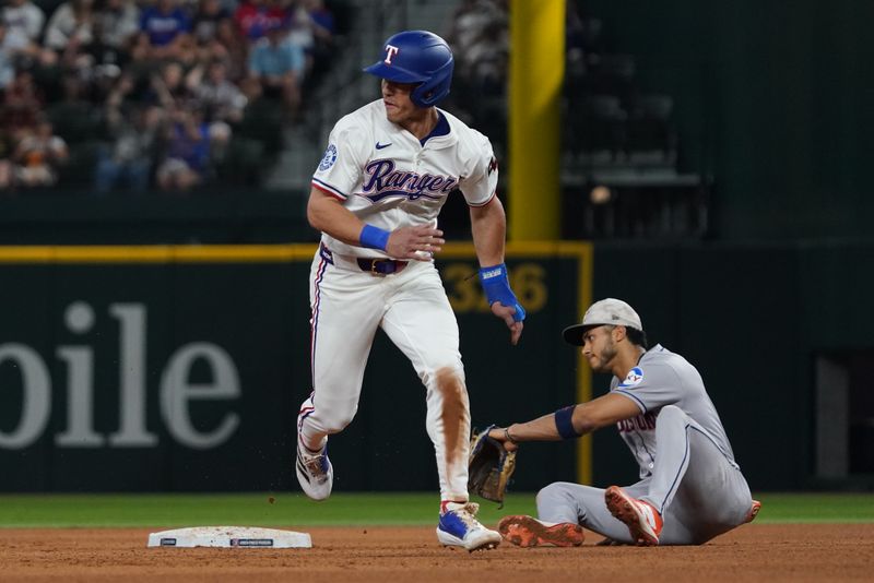May 17, 2025; Arlington, Texas, USA; Texas Rangers outfielder Sam Haggerty (0) advances to third base on an error as Houston Astros shortstop Jeremy Peña (3) looks on during the seventh inning at Globe Life Field. Mandatory Credit: Raymond Carlin III-Imagn Images