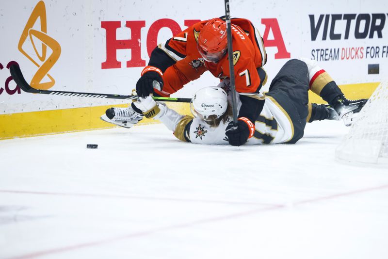 Nov 13, 2024; Anaheim, California, USA; Anaheim Ducks defenseman Radko Gudas (7) trips over Vegas Golden Knights center William Karlsson (71) during the first period of a hockey game at Honda Center. Mandatory Credit: Jessica Alcheh-Imagn Images