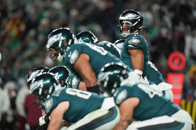 Philadelphia Eagles quarterback Jalen Hurts (1) looks down the line of scrimmage during the second half of an NFL football game against the Washington Commanders Thursday, Nov. 14, 2024, in Philadelphia. (AP Photo/Matt Slocum)