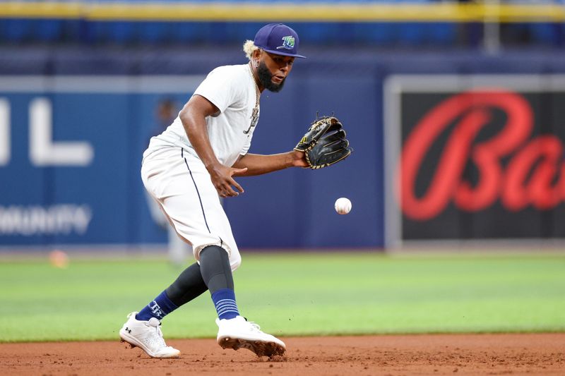 Aug 13, 2024; St. Petersburg, Florida, USA; Tampa Bay Rays third baseman Junior Caminero (13) takes fielding practice before a game against the Houston Astros at Tropicana Field. Mandatory Credit: Nathan Ray Seebeck-USA TODAY Sports