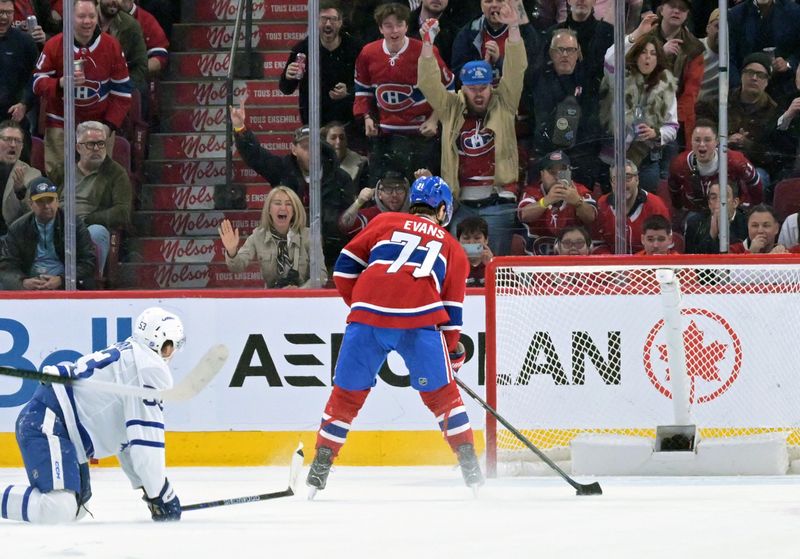 Mar 10, 2026; Montreal, Quebec, CAN; Montreal Canadiens forward Jake Evans (71) scores an empty net goal against the Toronto Maple Leafs during the third period at the  Bell Centre. Mandatory Credit: Eric Bolte-Imagn Images
