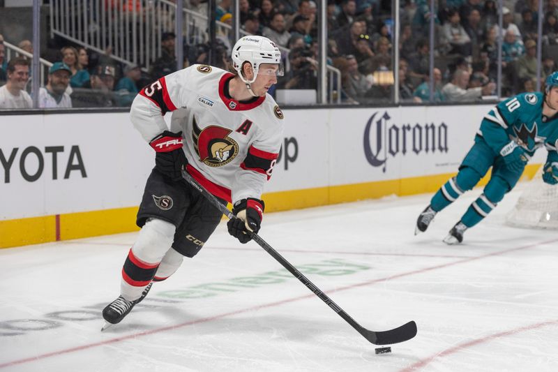 Nov 22, 2025; San Jose, California, USA;  Ottawa Senators defenseman Jake Sanderson (85) controls the puck during the second period against the San Jose Sharks at SAP Center at San Jose. Mandatory Credit: Stan Szeto-Imagn Images