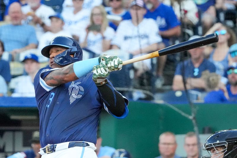 May 17, 2024; Kansas City, Missouri, USA;  Kansas City Royals catcher Salvador Perez (13) hits an RBI single against the Oakland Athletics in the first inning at Kauffman Stadium. Mandatory Credit: Denny Medley-USA TODAY Sports