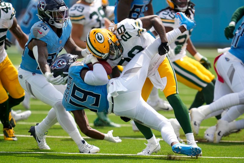 Tennessee Titans' Jha'Quan Jackson is stopped by Green Bay Packers' Xavier McKinney during the first half of an NFL football game Sunday, Sept. 22, 2024, in Nashville, Tenn. (AP Photo/George Walker IV)