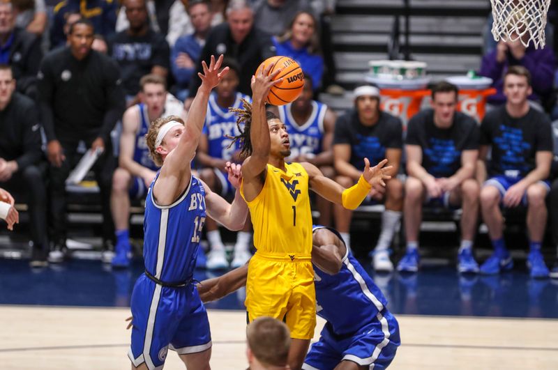 Feb 3, 2024; Morgantown, West Virginia, USA; West Virginia Mountaineers guard Noah Farrakhan (1) shoots in the lane during the first half against the Brigham Young Cougars at WVU Coliseum. Mandatory Credit: Ben Queen-USA TODAY Sports