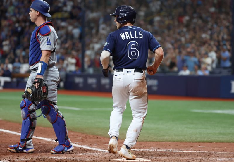 May 27, 2023; St. Petersburg, Florida, USA;  Tampa Bay Rays second baseman Taylor Walls (6) scores a run as Los Angeles Dodgers catcher Will Smith (16) looks on during the ninth inning at Tropicana Field. Mandatory Credit: Kim Klement-USA TODAY Sports