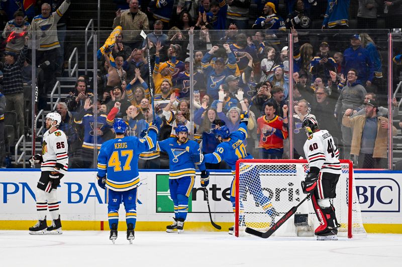 Dec 23, 2023; St. Louis, Missouri, USA;  St. Louis Blues defenseman Justin Faulk (72) is congratulated by teammates after scoring against the Chicago Blackhawks during the third period at Enterprise Center. Mandatory Credit: Jeff Curry-USA TODAY Sports