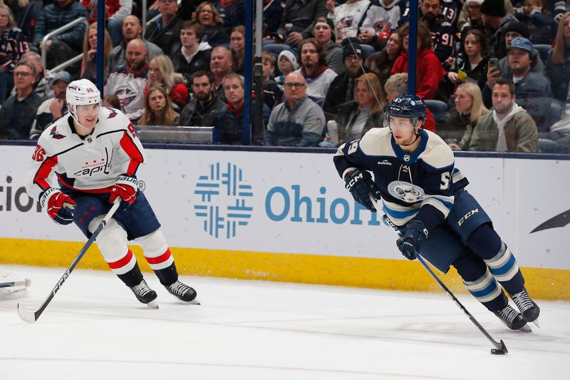 Dec 21, 2023; Columbus, Ohio, USA; Columbus Blue Jackets right wing Yegor Chinakhov (59) controls the puck as Washington Capitals right wing Nicolas Aube-Kubel (96) trails the play during the third period at Nationwide Arena. Mandatory Credit: Russell LaBounty-USA TODAY Sports