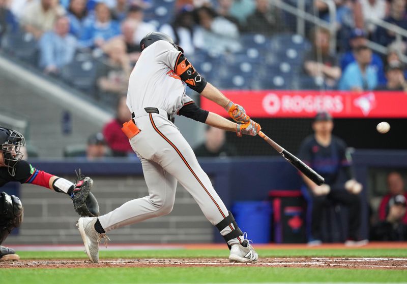 Jun 3, 2024; Toronto, Ontario, CAN; Baltimore Orioles center fielder Colton Cowser (17) hits an RBI double against the Toronto Blue Jays during the fourth inning at Rogers Centre. Mandatory Credit: Nick Turchiaro-USA TODAY Sports