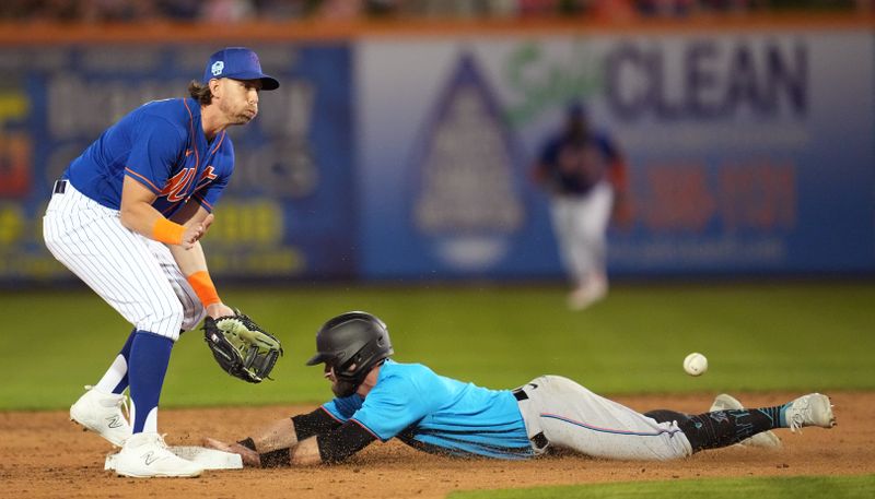 Feb 25, 2023; Port St. Lucie, Florida, USA;  Miami Marlins second baseman Jon Berti (5) steals second base as New York Mets second baseman Jeff McNeil (1) covers on the play in the third inning at Clover Park. Mandatory Credit: Jim Rassol-USA TODAY Sports