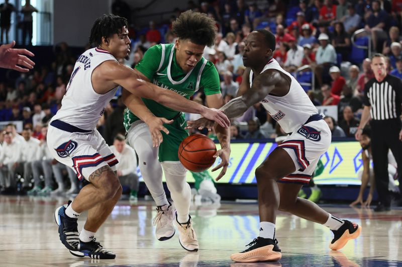 Jan 28, 2024; Boca Raton, Florida, USA; North Texas Mean Green guard CJ Noland (22) drives to the basket against Florida Atlantic Owls guard Bryan Greenlee (4) and guard Johnell Davis (1) during the first half at Eleanor R. Baldwin Arena. Mandatory Credit: Sam Navarro-USA TODAY Sports