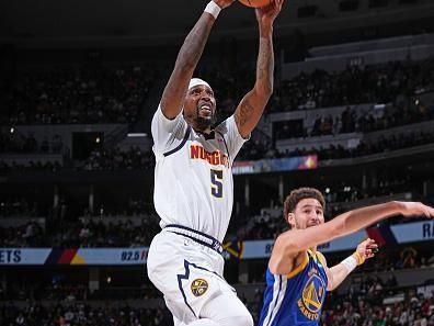 DENVER, CO - DECEMBER 25: Kentavious Caldwell-Pope #5 of the Denver Nuggets drives to the basket during the game against the Golden State Warriors on December 25, 2023 at the Ball Arena in Denver, Colorado. NOTE TO USER: User expressly acknowledges and agrees that, by downloading and/or using this Photograph, user is consenting to the terms and conditions of the Getty Images License Agreement. Mandatory Copyright Notice: Copyright 2023 NBAE (Photo by Garrett Ellwood/NBAE via Getty Images)