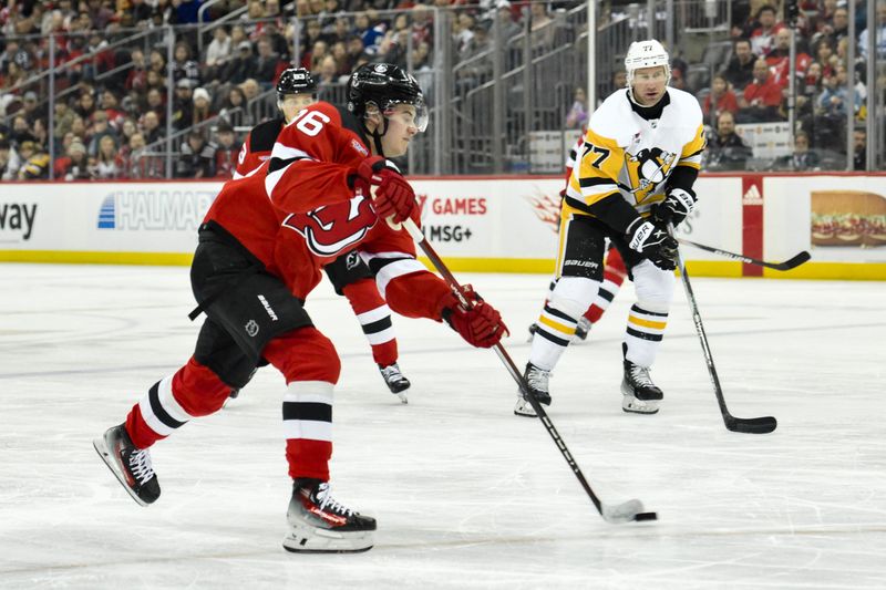 Apr 2, 2024; Newark, New Jersey, USA; New Jersey Devils center Jack Hughes (86) takes a shot as Pittsburgh Penguins center Jeff Carter (77) defends during the second period at Prudential Center. Mandatory Credit: John Jones-USA TODAY Sports