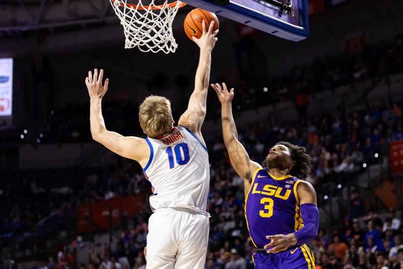 Feb 13, 2024; Gainesville, Florida, USA; Florida Gators forward Thomas Haugh (10) blocks a shot from LSU Tigers guard Jalen Cook (3) during the first half at Exactech Arena at the Stephen C. O'Connell Center. Mandatory Credit: Matt Pendleton-USA TODAY Sports