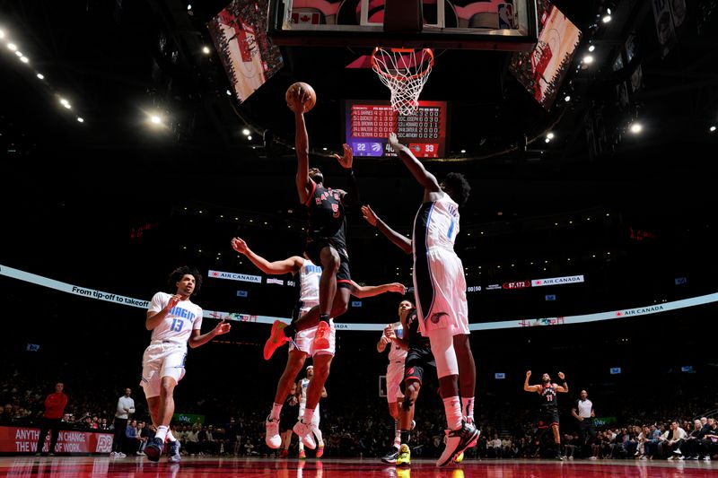 TORONTO, CANADA - JANUARY 3: Immanuel Quickley #5 of the Toronto Raptors drives to the basket during the game against the Orlando Magic on January 3, 2025 at the Scotiabank Arena in Toronto, Ontario, Canada.  NOTE TO USER: User expressly acknowledges and agrees that, by downloading and or using this Photograph, user is consenting to the terms and conditions of the Getty Images License Agreement.  Mandatory Copyright Notice: Copyright 2025 NBAE(Photo by Mark Blinch/NBAE via Getty Images)