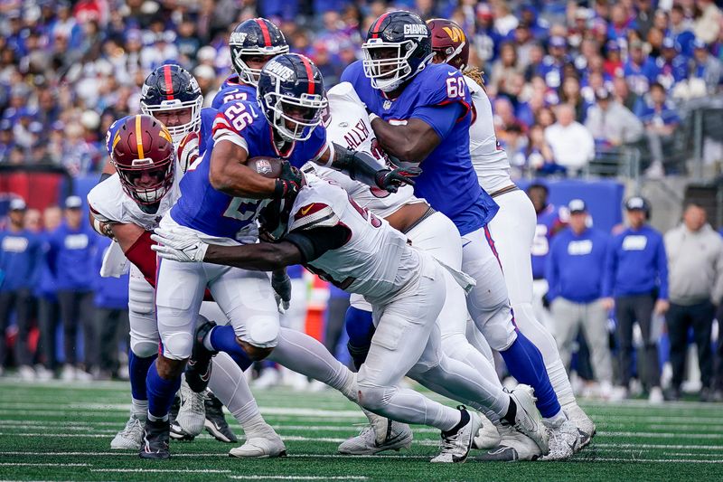 New York Giants running back Saquon Barkley (26) runs with the ball during an NFL football game against the Washington Commanders, Sunday Oct. 22, 2023, in East Rutherford, N.J. (AP Photo/Bryan Woolston)