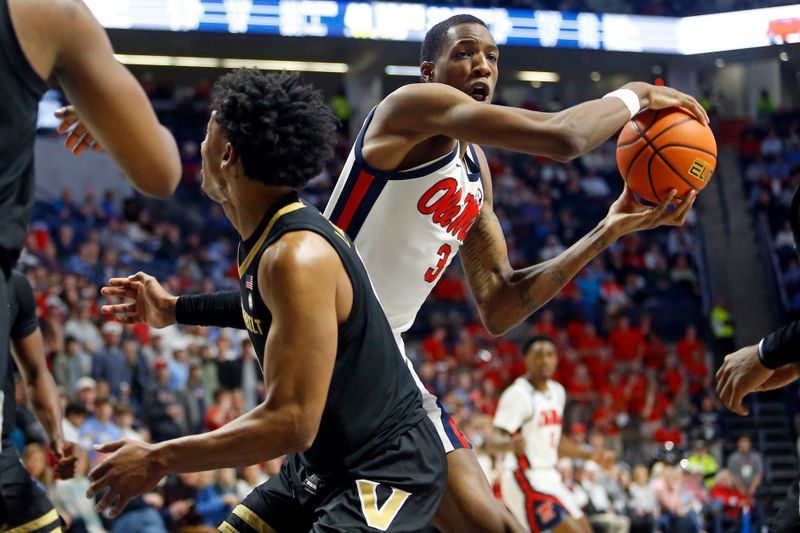 Jan 13, 2024; Oxford, Mississippi, USA; Mississippi Rebels forward Jamarion Sharp (3) grabs a rebound over Vanderbilt Commodores guard Tyrin Lawrence (0) during the second half at The Sandy and John Black Pavilion at Ole Miss. Mandatory Credit: Petre Thomas-USA TODAY Sports