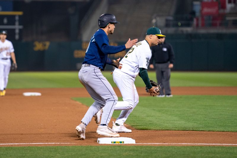 Sep 19, 2023; Oakland, California, USA; Seattle Mariners second baseman Sam Haggerty (0) advances to third base on a throwing error by Oakland Athletics relief pitcher Dany Jimenez (not pictured) during the seventh inning at Oakland-Alameda County Coliseum. Mandatory Credit: Neville E. Guard-USA TODAY Sports