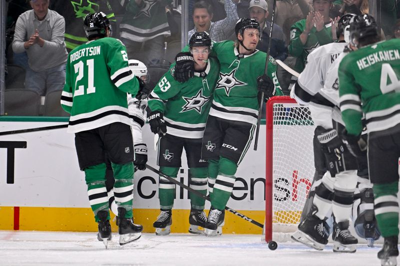 Oct 23, 2025; Dallas, Texas, USA; Dallas Stars center Wyatt Johnston (53) and left wing Jason Robertson (21) and center Roope Hintz (24) celebrates a power play goal scored by Johnston against the Los Angeles Kings during the third period at the American Airlines Center. Mandatory Credit: Jerome Miron-Imagn Images