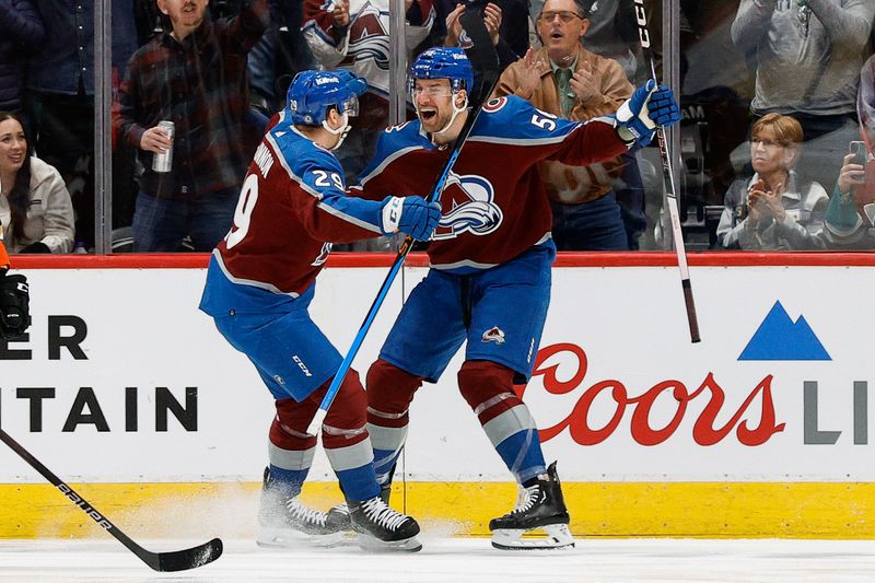 Dec 5, 2023; Denver, Colorado, USA; Colorado Avalanche defenseman Kurtis MacDermid (56) celebrates his goal with center Nathan MacKinnon (29) in the first period against the Anaheim Ducks at Ball Arena. Mandatory Credit: Isaiah J. Downing-USA TODAY Sports