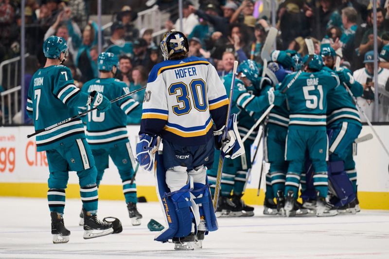 Apr 6, 2024; San Jose, California, USA; St. Louis Blues goaltender Joel Hofer (30) skates past the San Jose Sharks as they celebrate the game-winning goal during the overtime period at SAP Center at San Jose. Mandatory Credit: Robert Edwards-USA TODAY Sports