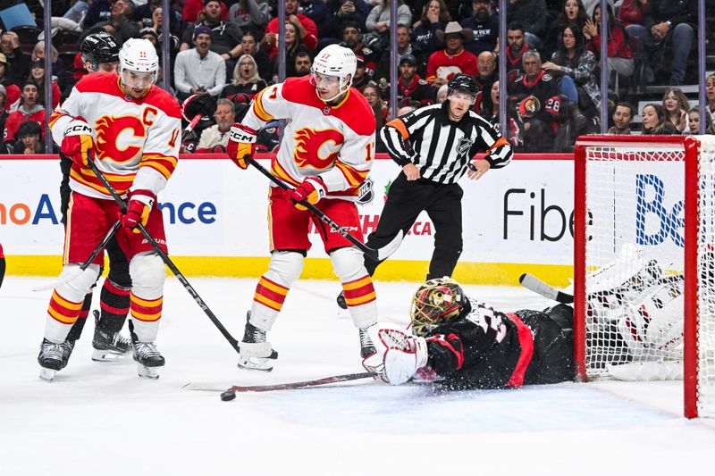 Nov 25, 2024; Ottawa, Ontario, CAN; Ottawa Senators goalie Anton Forsberg (31) makes a save against the Calgary Flames during the second period at Canadian Tire Centre. Mandatory Credit: David Kirouac-Imagn Images