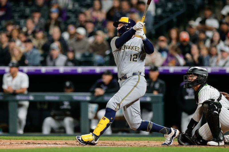 Apr 9, 2025; Denver, Colorado, USA; Milwaukee Brewers first baseman Rhys Hoskins (12) watches his ball on a sacrifice fly RBI in the fifth inning against the Colorado Rockies at Coors Field. Mandatory Credit: Isaiah J. Downing-Imagn Images