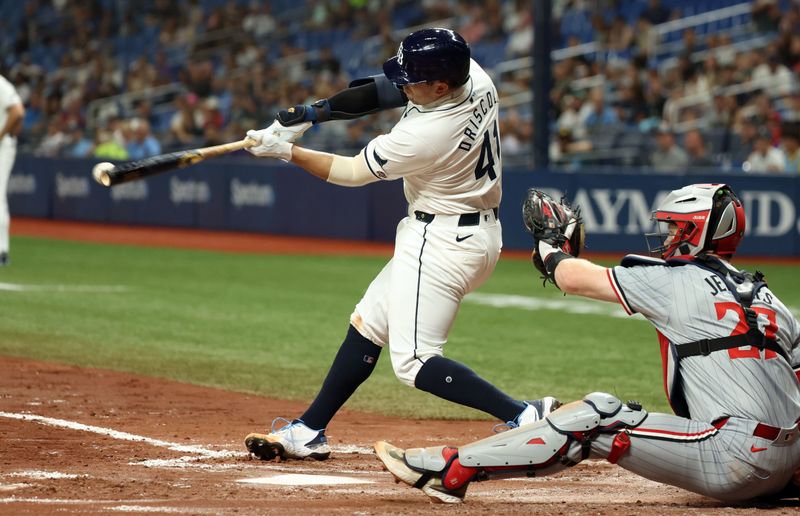 Sep 3, 2024; St. Petersburg, Florida, USA; Tampa Bay Rays catcher Logan Driscoll (41) hits an RBI single for his first career MLB hit during the third inning against the Minnesota Twins at Tropicana Field. Mandatory Credit: Kim Klement Neitzel-Imagn Images