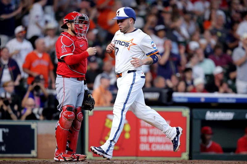 Apr 13, 2025; Houston, Texas, USA; Houston Astros catcher Victor Caratini (17) crosses home plate to score a run against the Los Angeles Angels during the second inning at Daikin Park. Mandatory Credit: Erik Williams-Imagn Images
