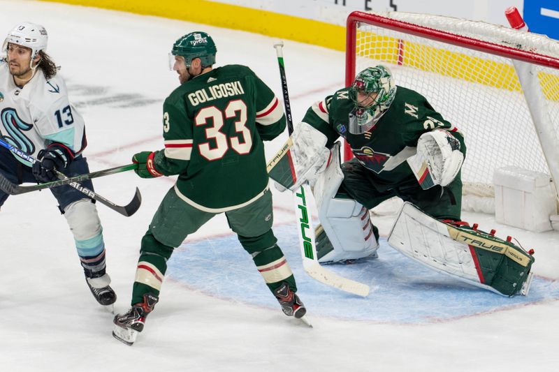 Apr 18, 2024; Saint Paul, Minnesota, USA; Minnesota Wild goaltender Marc-Andre Fleury (29) looks to make a save through defenseman Alex Goligoski (33) and Seattle Kraken left wing Brandon Tanev (13) in the second period at Xcel Energy Center. Mandatory Credit: Matt Blewett-USA TODAY Sports