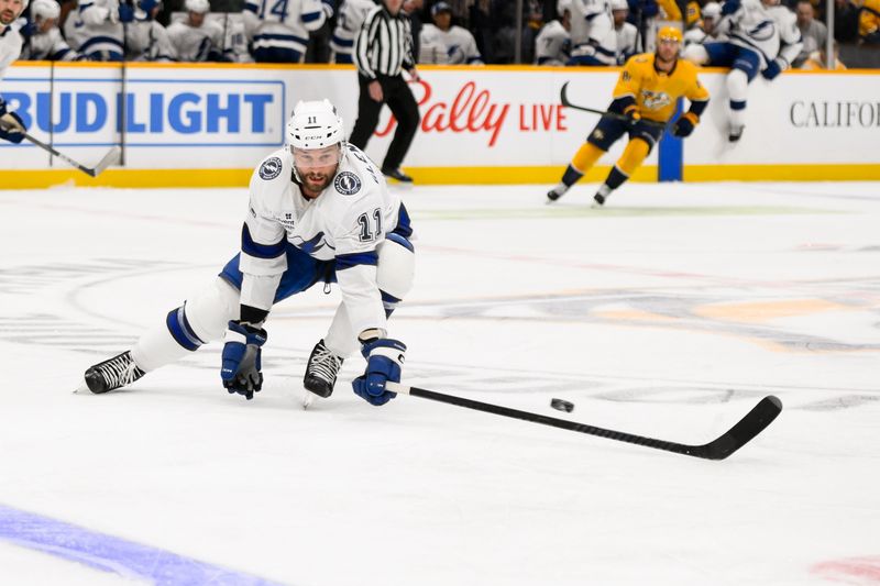 Nov 29, 2024; Nashville, Tennessee, USA;  Tampa Bay Lightning center Luke Glendening (11) blocks the puck against the Nashville Predators during the first period at Bridgestone Arena. Mandatory Credit: Steve Roberts-Imagn Images