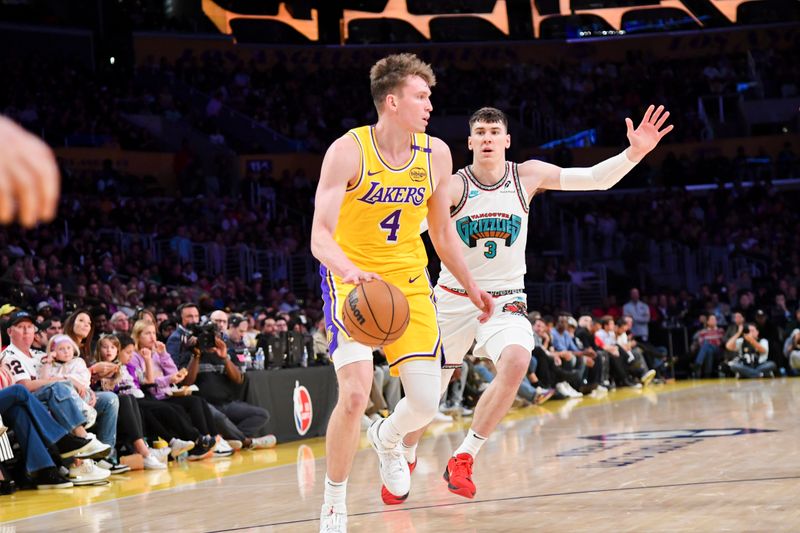 LOS ANGELES, CA - OCTOBER 22:  Dalton Knecht #4 of the Los Angeles Lakers dribbles the ball during the game against the Memphis Grizzlies on October 22, 2024 at Crypto.com Arena in Los Angeles, California. NOTE TO USER: User expressly acknowledges and agrees that, by downloading and/or using this Photograph, user is consenting to the terms and conditions of the Getty Images License Agreement. Mandatory Copyright Notice: Copyright 2024 NBAE (Photo by Juan Ocampo/NBAE via Getty Images)