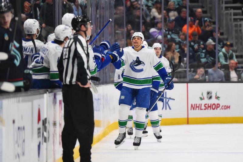 Nov 24, 2023; Seattle, Washington, USA; Vancouver Canucks center Dakota Joshua (81) celebrates with the bench after scoring a goal against the Seattle Kraken during the second period at Climate Pledge Arena. Mandatory Credit: Steven Bisig-USA TODAY Sports