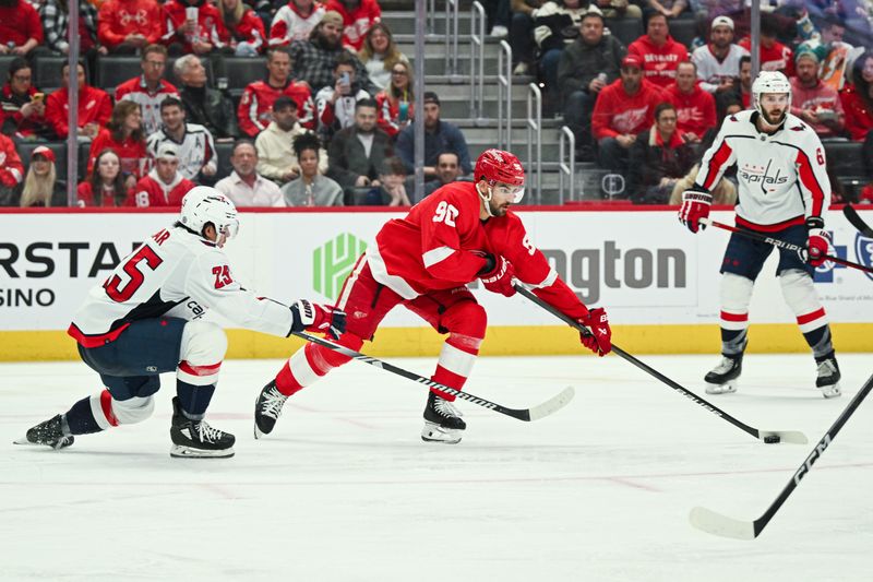 Feb 27, 2024; Detroit, Michigan, USA; Detroit Red Wings center Joe Veleno (90) skates past Washington Capitals defenseman Ethan Bear (25) during the second period at Little Caesars Arena. Mandatory Credit: Tim Fuller-USA TODAY Sports