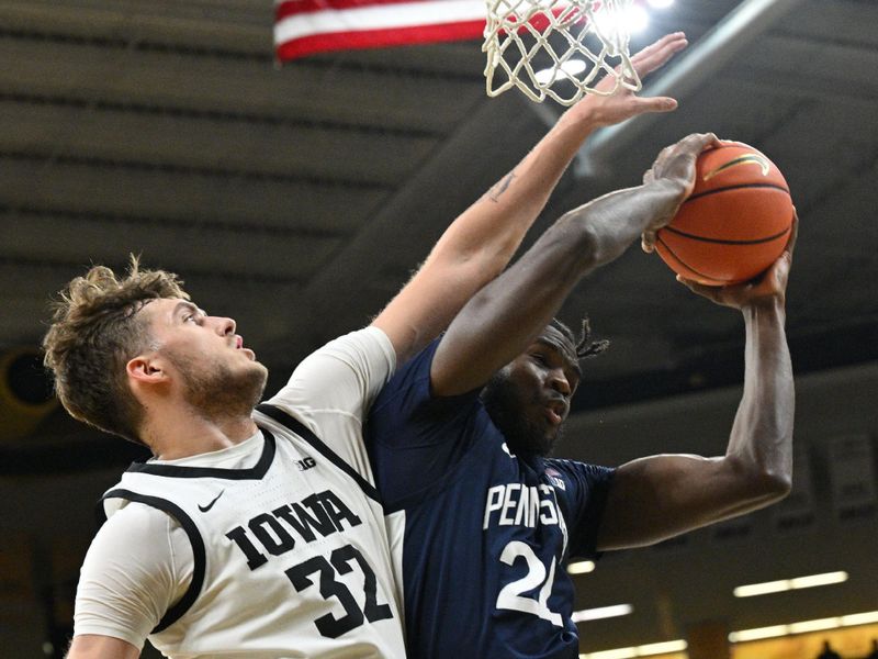 Feb 27, 2024; Iowa City, Iowa, USA; Iowa Hawkeyes forward Owen Freeman (32) defends the shot of Penn State Nittany Lions forward Qudus Wahab (22) during the first half at Carver-Hawkeye Arena. Mandatory Credit: Jeffrey Becker-USA TODAY Sports