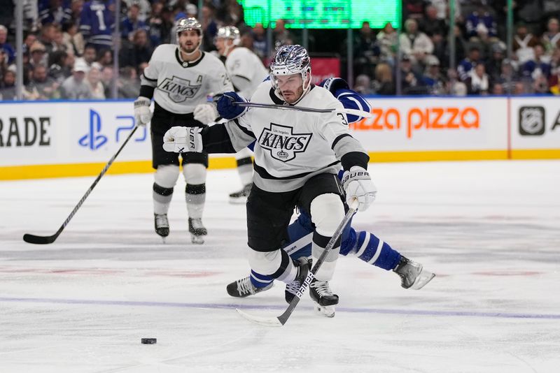 Oct 31, 2023; Toronto, Ontario, CAN; Los Angeles Kings defenseman Matt Roy (3) tries to get clear of Toronto Maple Leafs forward Calle Jarnkrok (19) during the second period at Scotiabank Arena. Mandatory Credit: John E. Sokolowski-USA TODAY Sports