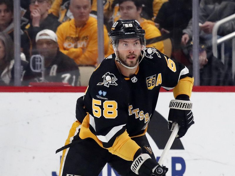 Feb 18, 2024; Pittsburgh, Pennsylvania, USA;  Pittsburgh Penguins defenseman Kris Letang (58) skates with the puck against the Los Angeles Kings during the first period at PPG Paints Arena. Mandatory Credit: Charles LeClaire-USA TODAY Sports