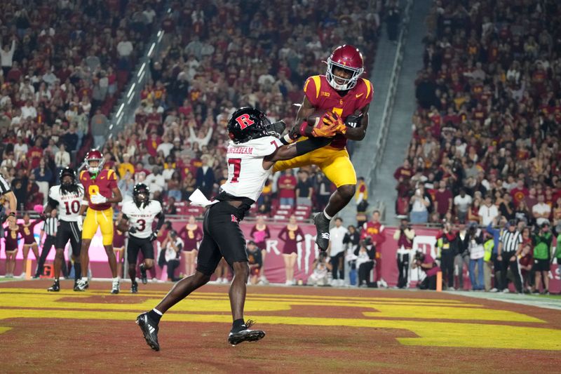 Oct 25, 2024; Los Angeles, California, USA; Southern California Trojans wide receiver Zachariah Branch (1) attempts to catch the ball against Rutgers Scarlet Knights defensive back Robert Longerbeam (7) in the first half at United Airlines Field at Los Angeles Memorial Coliseum. Mandatory Credit: Kirby Lee-Imagn Images