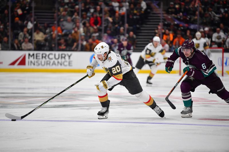 Dec 27, 2023; Anaheim, California, USA; Vegas Golden Knights center Chandler Stephenson (20) moves the puck ahead of Anaheim Ducks defenseman Jamie Drysdale (6) during the second period at Honda Center. Mandatory Credit: Gary A. Vasquez-USA TODAY Sports