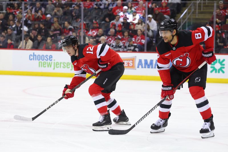 Mar 22, 2025; Newark, New Jersey, USA; New Jersey Devils center Cody Glass (12) and defenseman Johnathan Kovacevic (8) against the Ottawa Senators during the first period at Prudential Center. Mandatory Credit: Ed Mulholland-Imagn Images