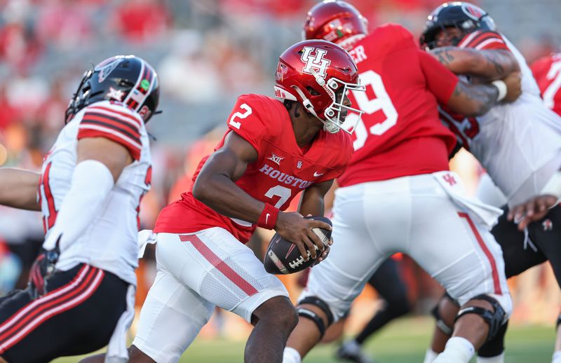 Oct 26, 2024; Houston, Texas, USA; Houston Cougars quarterback Zeon Chriss (2) runs with the ball during the first quarter against the Utah Utes at TDECU Stadium. Mandatory Credit: Troy Taormina-Imagn Images