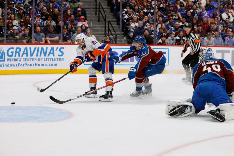 Oct 14, 2024; Denver, Colorado, USA; New York Islanders center Kyle Palmieri (21) scores on a shot as Colorado Avalanche defenseman Josh Manson (42) and goaltender Alexandar Georgiev (40) look on in the first period at Ball Arena. Mandatory Credit: Isaiah J. Downing-Imagn Images