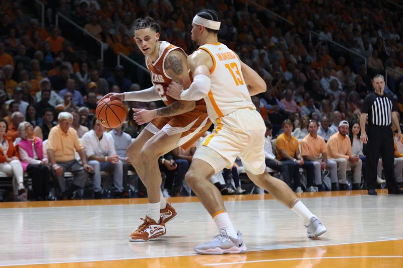 Jan 28, 2023; Knoxville, Tennessee, USA; Texas Longhorns forward Christian Bishop (32) moves the ball against Tennessee Volunteers forward Olivier Nkamhoua (13) during the second half at Thompson-Boling Arena. Mandatory Credit: Randy Sartin-USA TODAY Sports