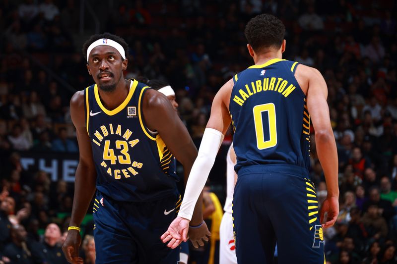 TORONTO, CANADA - NOVEMBER 18: Pascal Siakam #43 of the Indiana Pacers high fives Tyrese Haliburton #0 during the game against the Toronto Raptors on November 18, 2024 at the Scotiabank Arena in Toronto, Ontario, Canada.  NOTE TO USER: User expressly acknowledges and agrees that, by downloading and or using this Photograph, user is consenting to the terms and conditions of the Getty Images License Agreement.  Mandatory Copyright Notice: Copyright 2024 NBAE (Photo by Vaughn Ridley/NBAE via Getty Images)